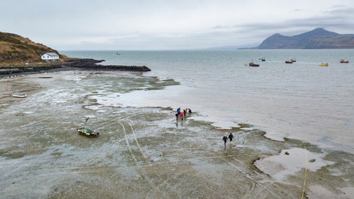 An aerial view of people monitoring a seagrass meadow at Porthdinllaen, Gwynedd